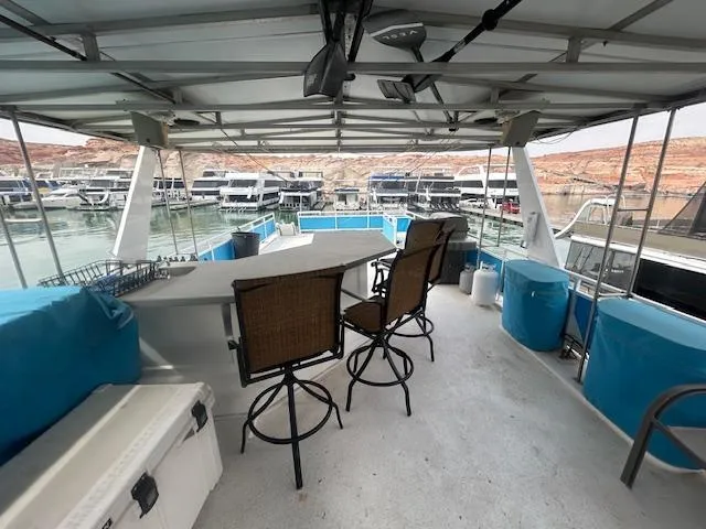 Slide: The Image of 1999 Skipperliner 59 x 14 houseboat interior with bar stools and marina view. - 29