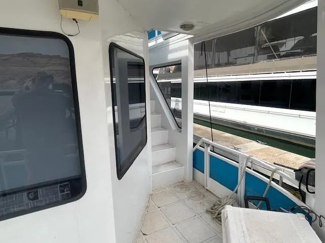 Slide: The Image of 1999 Skipperliner 59 x 14 houseboat interior with stairs and windows. - 4