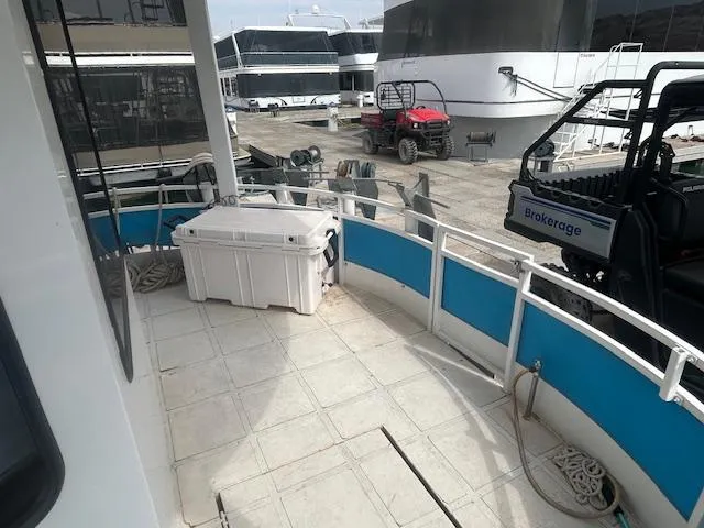 Slide: The Image of 1999 Skipperliner 59 x 14 houseboat deck with storage box and marina view. - 5