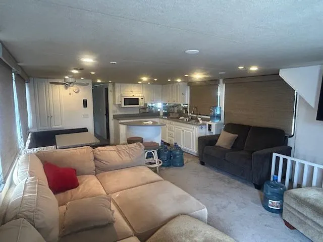 Slide: The Image of Interior of 1999 Skipperliner 59 x 14 houseboat with cozy seating and modern kitchen. - 6