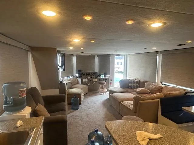 Slide: The Image of 1999 Skipperliner 59 x 14 houseboat interior with cozy seating and modern amenities. - 7