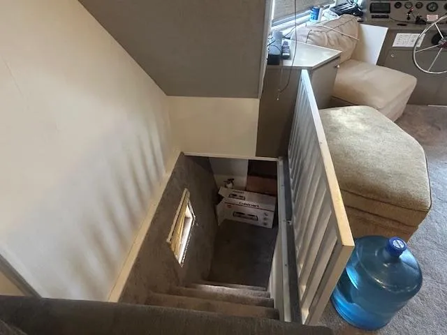 Slide: The Image of Staircase inside 1999 Skipperliner 59 x 14 houseboat with water jug and seating area. - 9