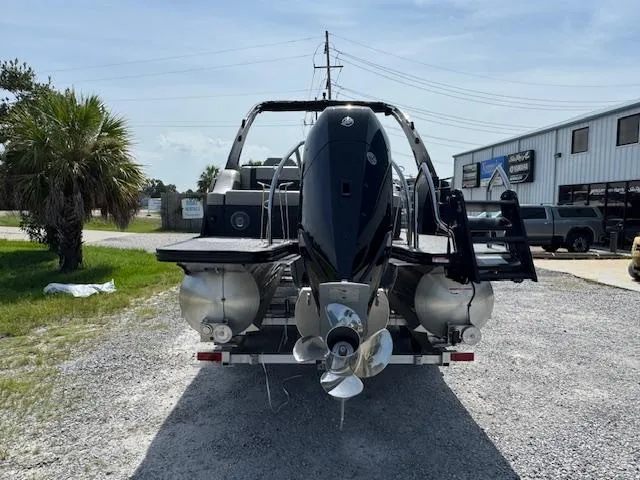 Slide: The Image of 2026 Barletta LUSSO 25 UCA pontoon boat on trailer, featuring sleek design and powerful outboard motor. - 10