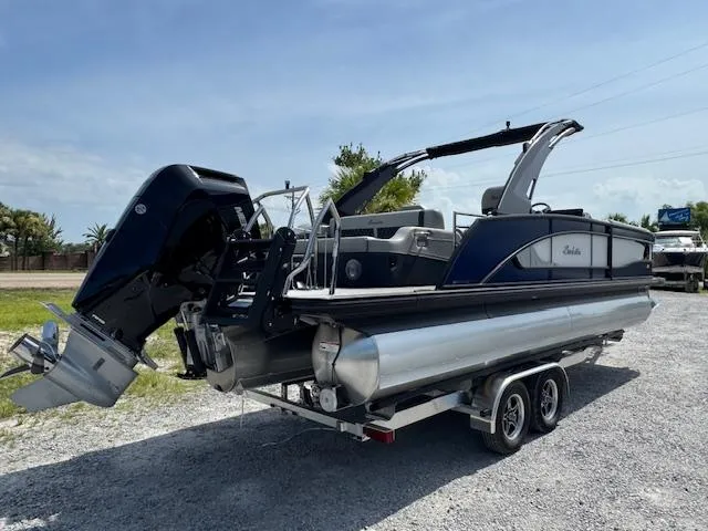 Slide: The Image of 2026 Barletta LUSSO 25 UCA pontoon boat on trailer, parked outdoors. - 11