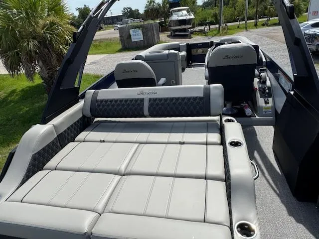 Slide: The Image of 2026 Barletta LUSSO 25 UCA pontoon boat on trailer, covered, parked outdoors. - 23
