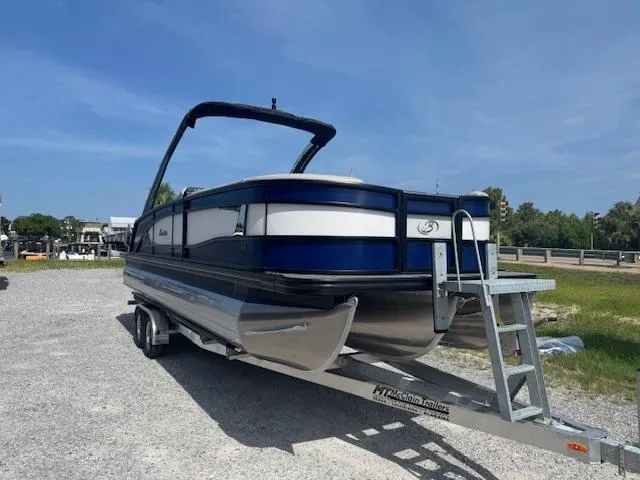 Slide: The Image of 2026 Barletta LUSSO 25 UCA pontoon boat on trailer, parked outdoors. - 3