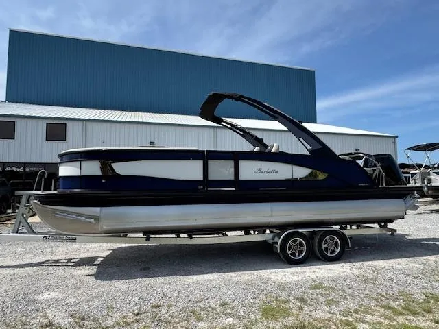 Slide: The Image of 2026 Barletta LUSSO 25 UCA pontoon boat on trailer, parked outdoors. - 6