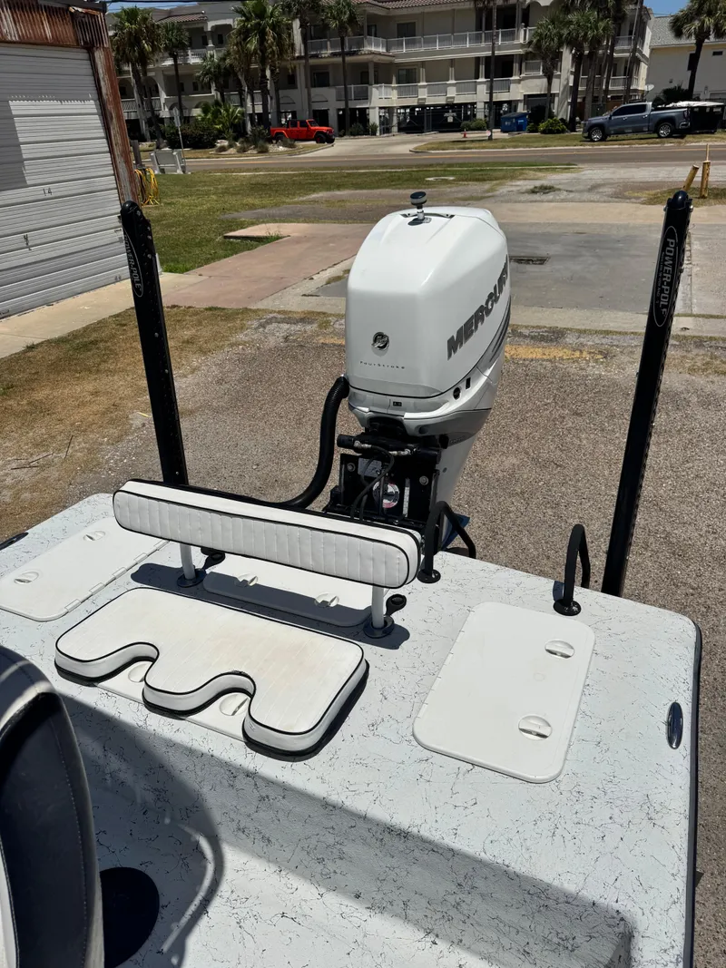 Slide: The Image of 2015 Haynie 25 Magnum boat with Mercury outboard motor in a coastal setting. - 7