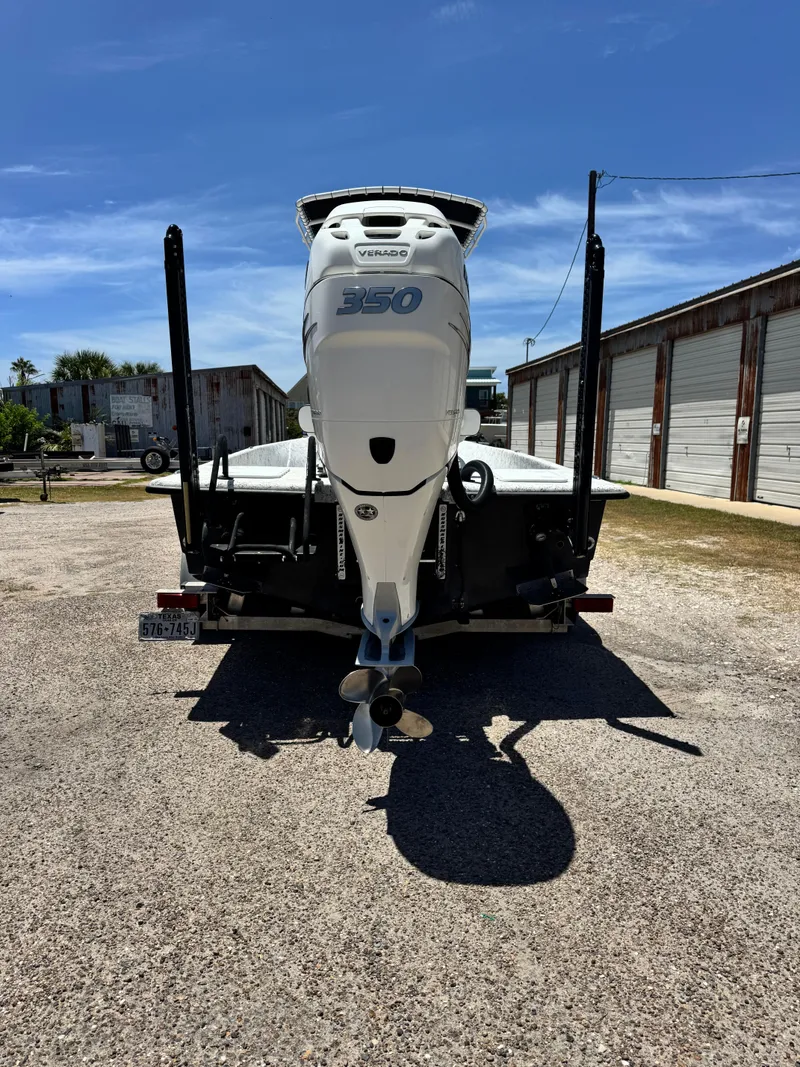 Slide: The Image of 2015 Haynie 25 Magnum boat with a 350 Verado engine, parked outdoors. - 8