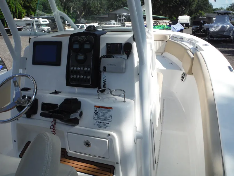 Slide: The Image of 2017 Sea Fox 266 Commander boat dashboard with steering wheel and navigation controls. - 10