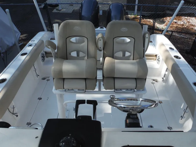 Slide: The Image of 2017 Sea Fox 266 Commander boat interior with dual captain's chairs and steering wheel. - 16