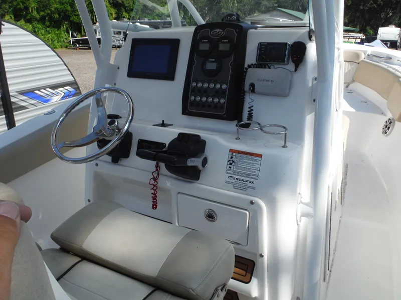Slide: The Image of 2017 Sea Fox 266 Commander boat console with steering wheel and navigation controls. - 18