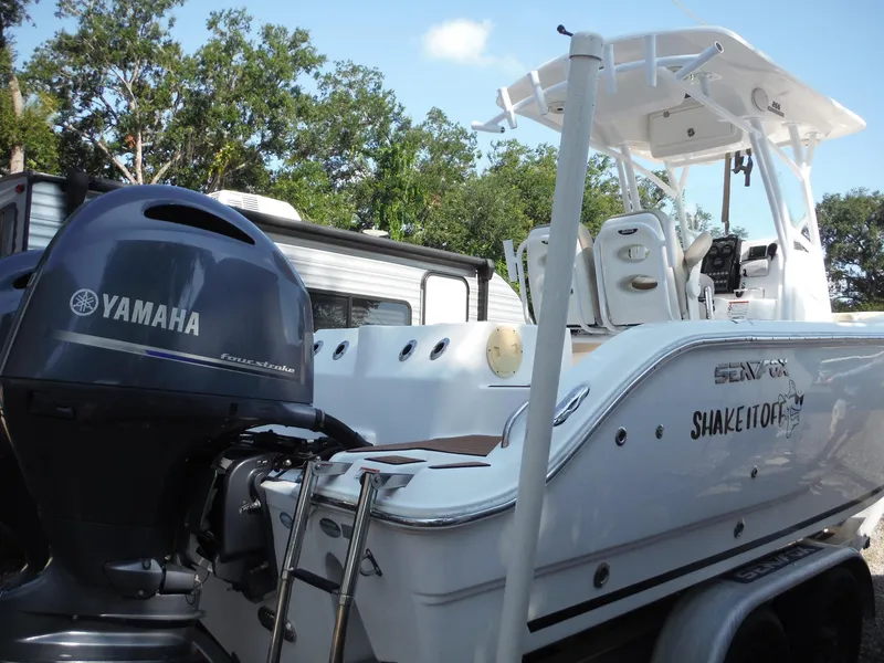 Slide: The Image of 2017 Sea Fox 266 Commander boat with Yamaha engine, parked outdoors. - 2