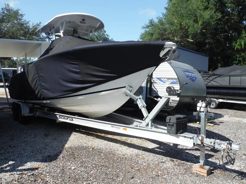 Slide: The Image of 2017 Sea Fox 266 Commander boat covered on a trailer, parked outdoors. - 4