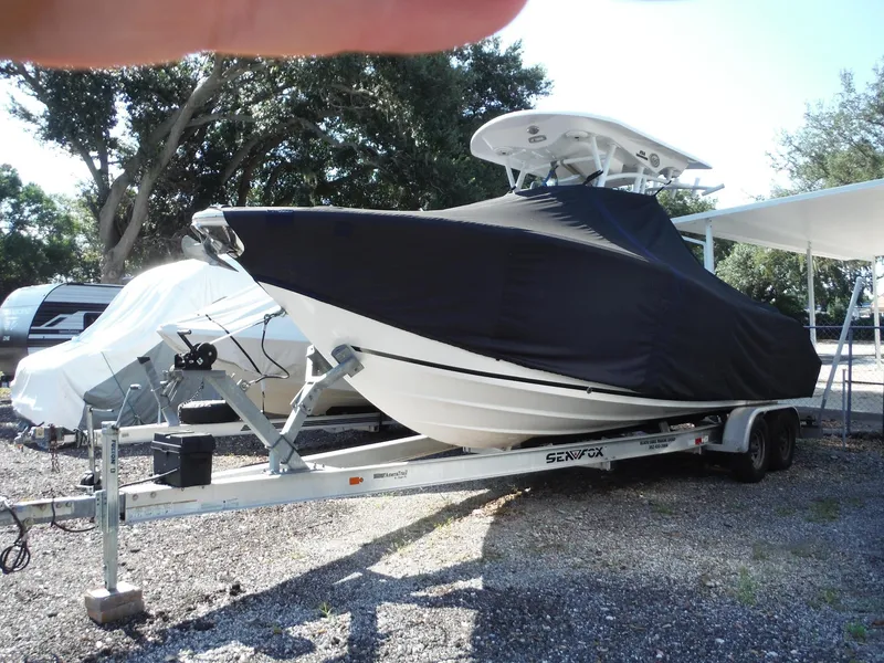 Slide: The Image of 2017 Sea Fox 266 Commander boat covered on trailer in outdoor storage. - 47