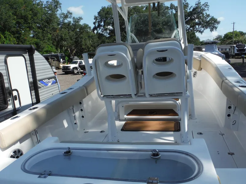 Slide: The Image of 2017 Sea Fox 266 Commander boat interior with seating and storage, parked outdoors. - 7