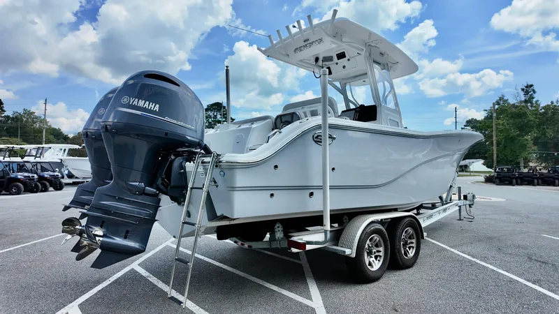 Slide: The Image of 2023 Sea Fox 268 Commander boat on trailer with Yamaha outboard motor, parked outdoors. - 13
