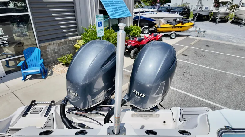 Slide: The Image of 2023 Sea Fox 268 Commander with dual outboard engines in a parking lot. - 3