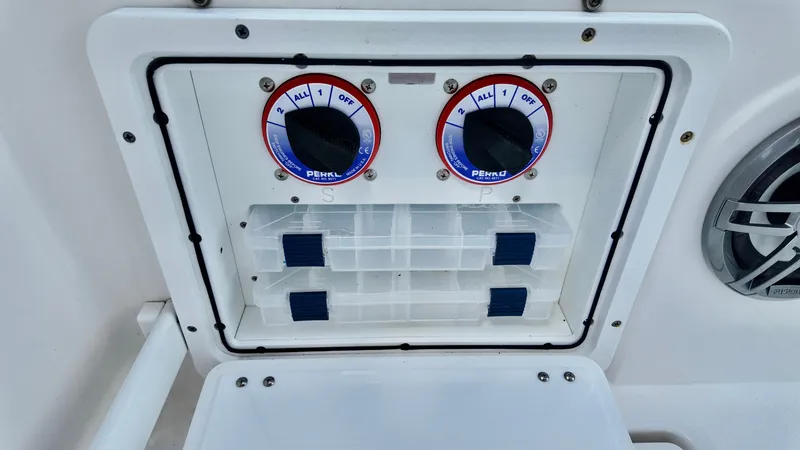 Slide: The Image of Control panel on 2023 Sea Fox 268 Commander boat with Perko switches and storage compartments. - 6