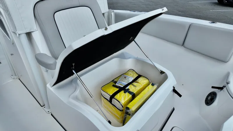 Slide: The Image of Open storage compartment on 2023 Sea Fox 268 Commander boat with yellow life jackets inside. - 7