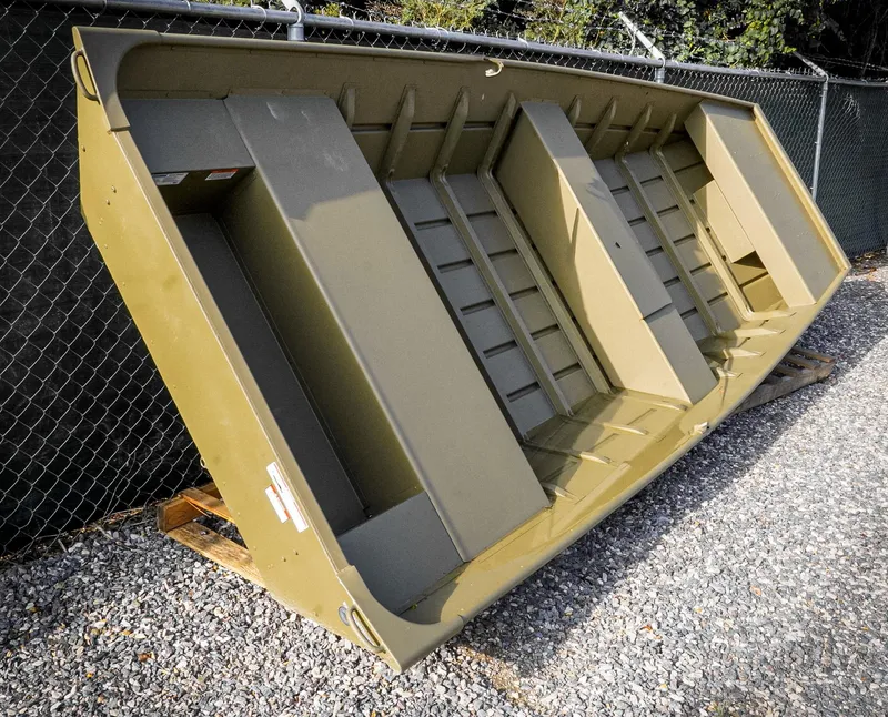 Slide: The Image of Trailer of 2025 G3 Gator Tough 1648 LW boat on gravel surface. - 2