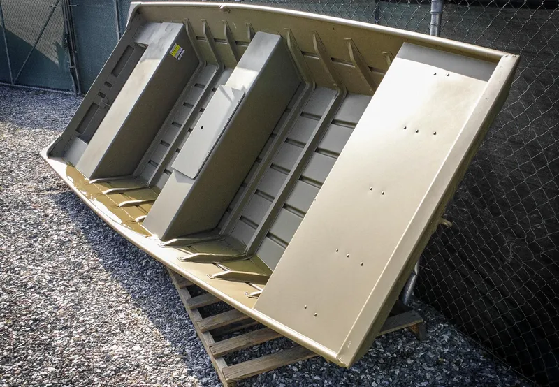 Slide: The Image of 2025 G3 Gator Tough 1648 LW boat with Yamaha 25 outboard motor, parked outdoors. - 5