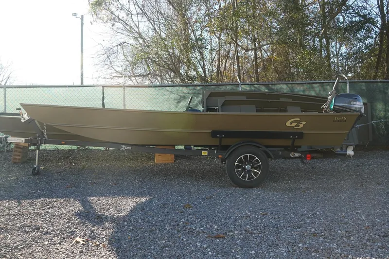 Slide: The Image of 2025 G3 Gator Tough 1648 LW boat on trailer, parked outdoors. - 6