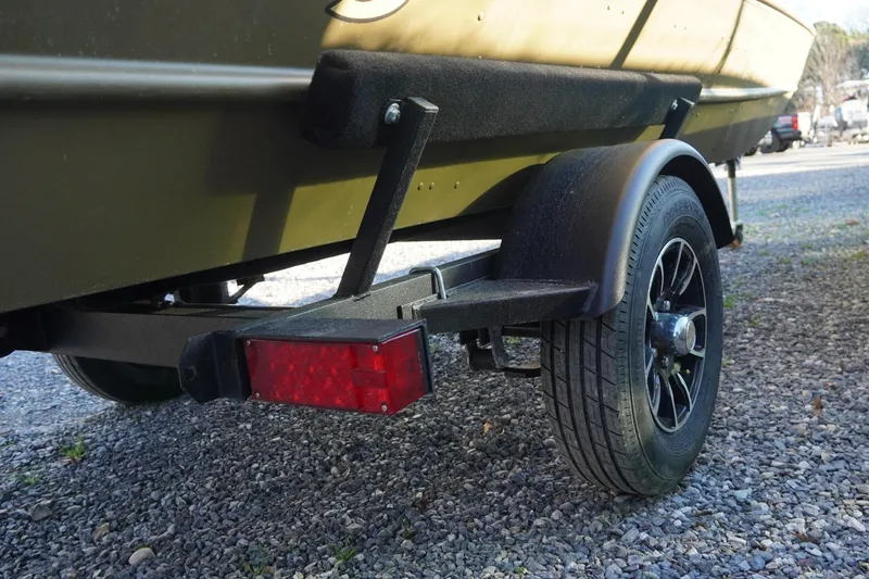 Slide: The Image of 2025 G3 Gator Tough 1648 LW boat trailer on gravel surface. - 8