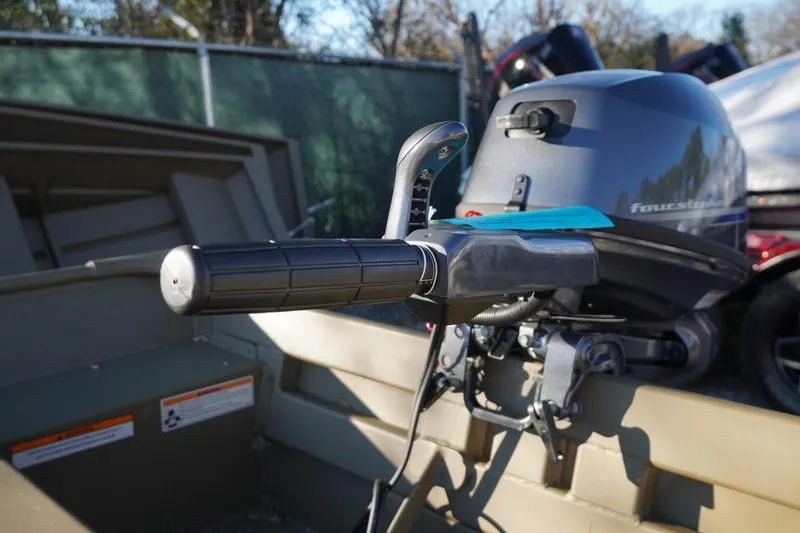 Slide: The Image of 2025 G3 Gator Tough 1648 LW boat with outboard motor and control handle. - 9