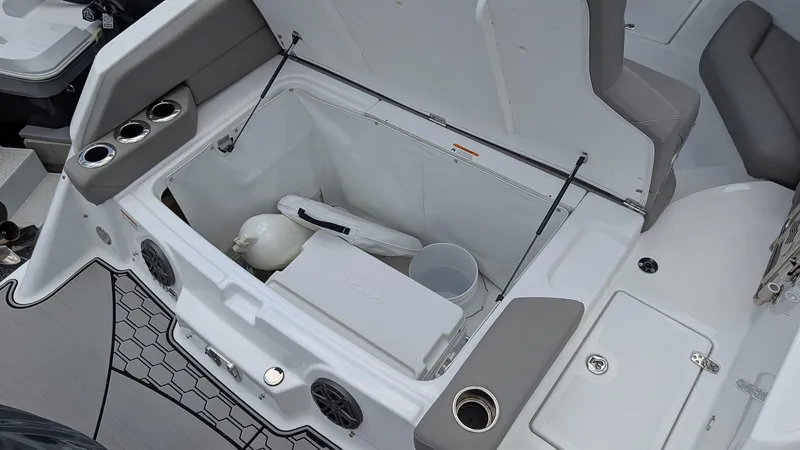 Slide: The Image of 2024 Four Winns HD8 OB boat storage compartment with seating and cup holders. - 10