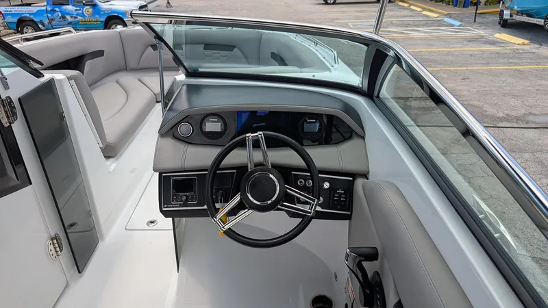 Slide: The Image of 2024 Four Winns HD8 OB boat interior with steering wheel and seating area. - 16