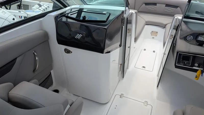 Slide: The Image of 2024 Four Winns HD8 OB boat interior with seating and control panel. - 19