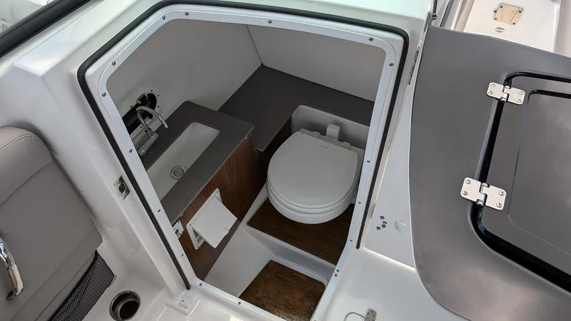 Slide: The Image of 2024 Four Winns HD8 OB boat interior bathroom with sink and toilet. - 20