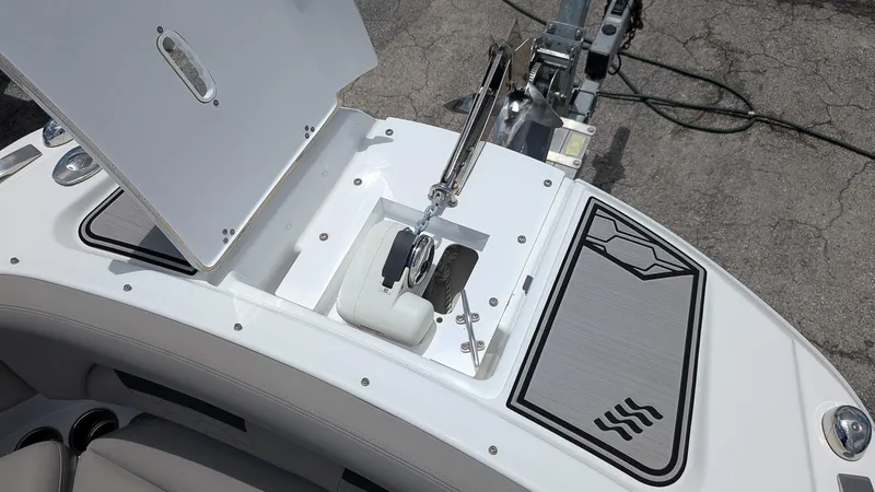 Slide: The Image of 2024 Four Winns HD8 OB boat anchor compartment with open hatch and sleek design. - 23
