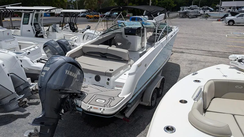Slide: The Image of 2024 Four Winns HD8 OB boat with Yamaha outboard motor in a marina setting. - 3