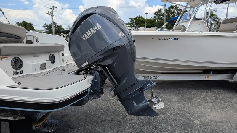Slide: The Image of 2024 Four Winns HD8 OB boat with Yamaha outboard motor, parked on a trailer. - 5