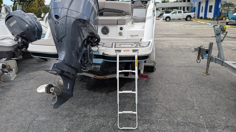 Slide: The Image of 2024 Four Winns HD8 OB boat with Yamaha outboard motor and boarding ladder. - 6