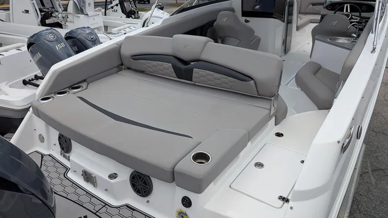 Slide: The Image of 2024 Four Winns HD8 OB boat interior with gray seating and cup holders. - 8