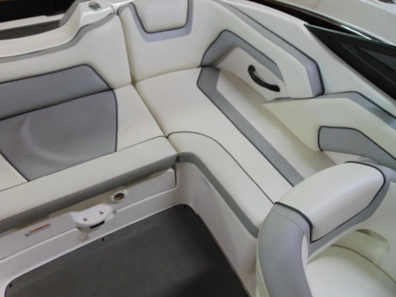 Slide: The Image of 2017 Yamaha Boats SX190 interior seating with white and gray upholstery. - 11