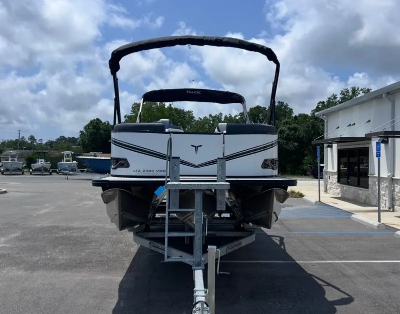 Slide: The Image of 2025 Tahoe LTZ VRB 23T DX boat on trailer outdoors. - 8