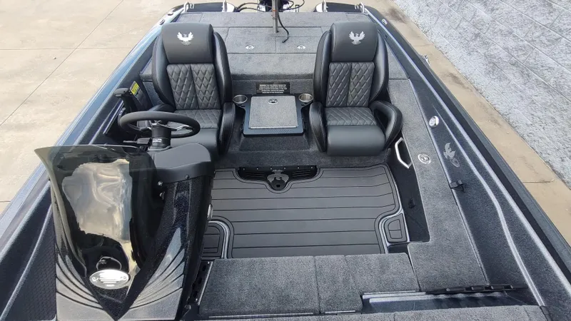 Slide: The Image of 2026 Phoenix 919 ZXL boat interior with dual black leather seats and sleek dashboard design. - 2