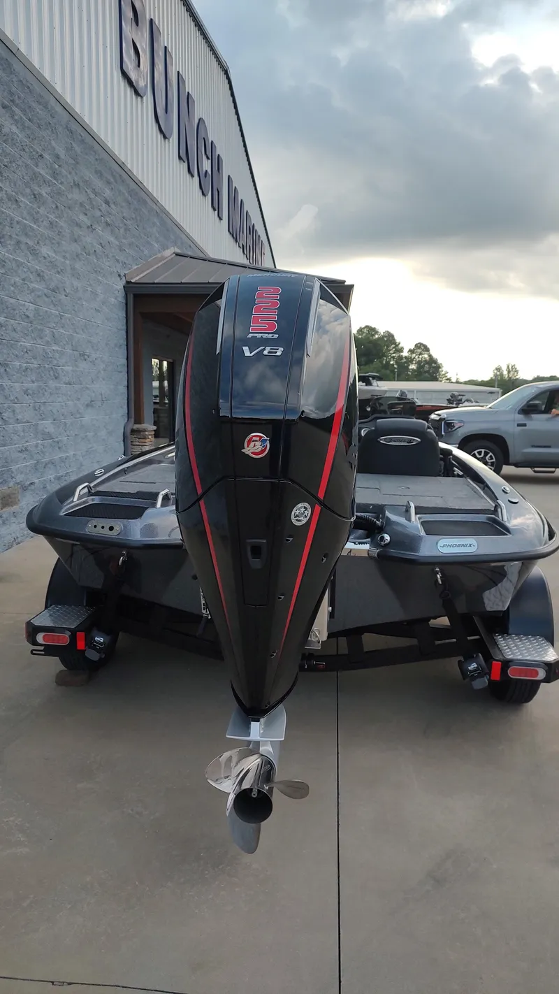 Slide: The Image of 2026 Phoenix 919 ZXL boat with V8 engine, parked outside dealership. - 7