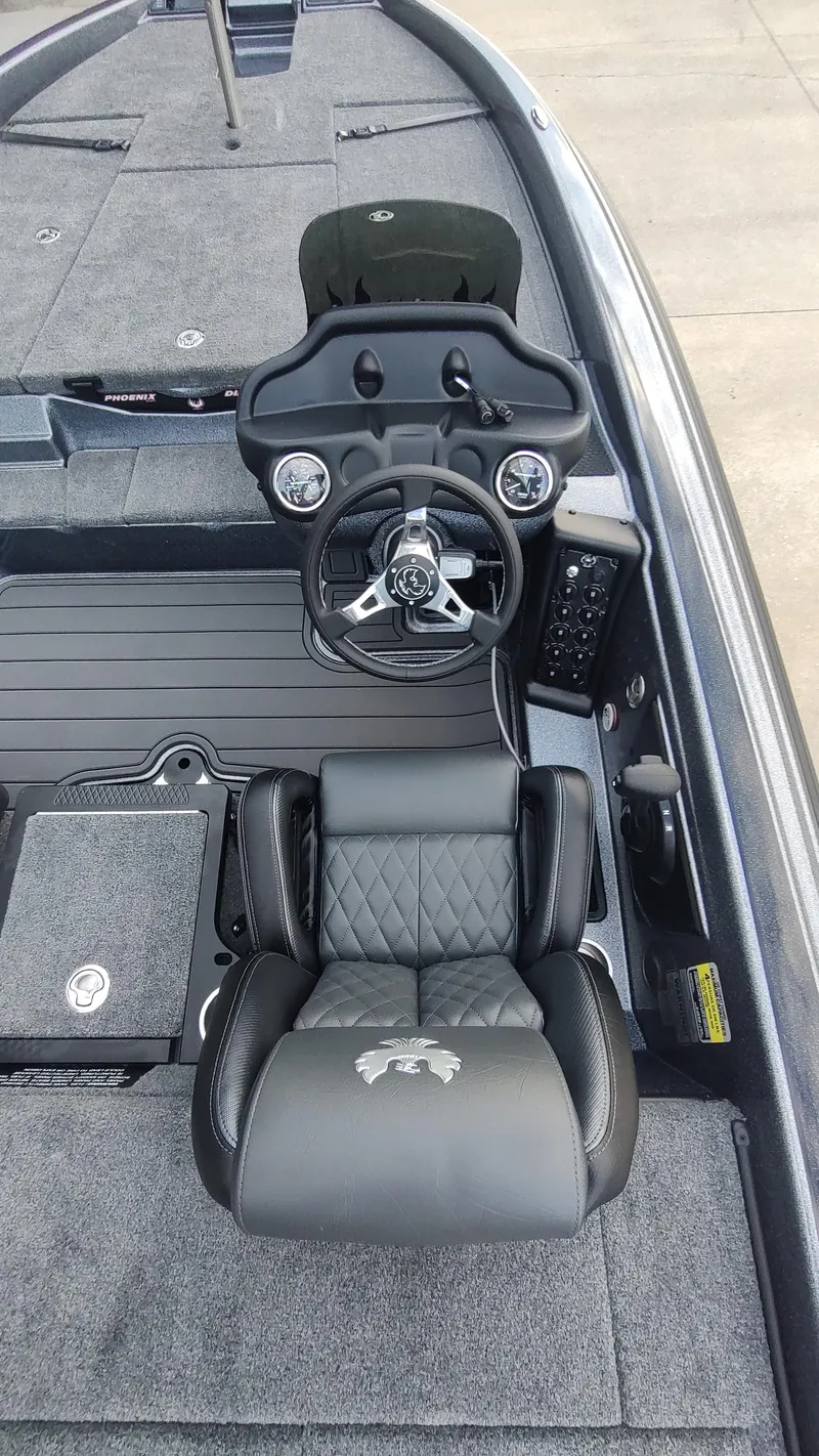 Slide: The Image of 2026 Phoenix 919 ZXL boat interior with steering wheel and cushioned seat. - 8