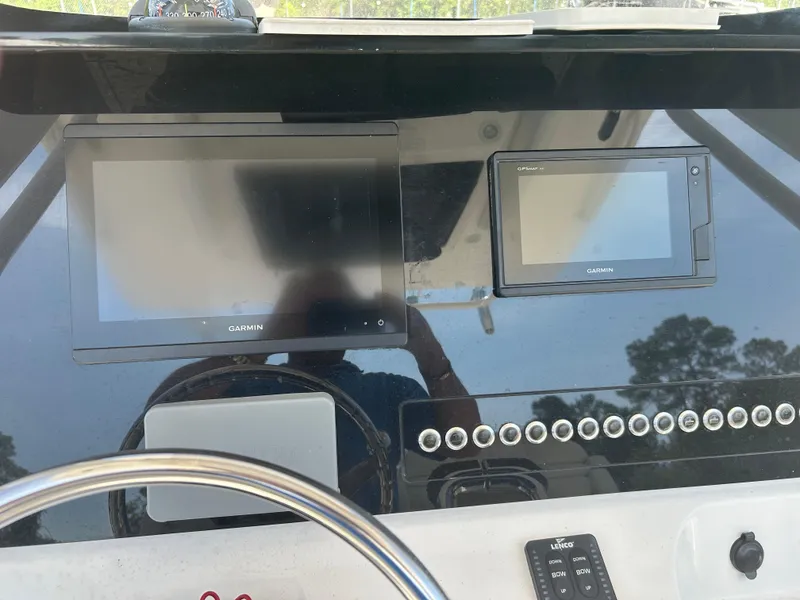 Slide: The Image of 2019 Edgewater 262CC boat dashboard with Garmin displays and controls. - 11