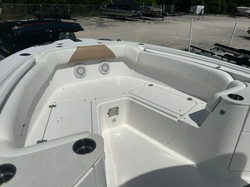 Slide: The Image of 2019 Edgewater 262CC boat interior with white seating and cup holders. - 13