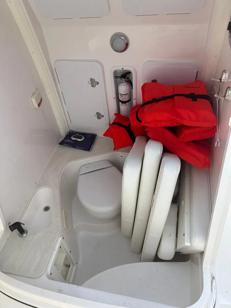 Slide: The Image of Interior of 2019 Edgewater 262CC boat with life jackets and safety equipment. - 17