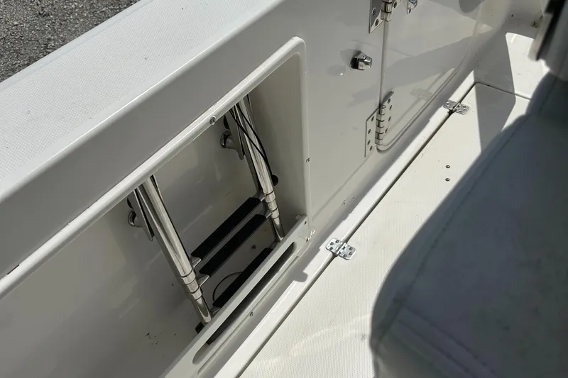 Slide: The Image of 2019 Edgewater 262CC boat interior showing storage compartment and ladder. - 20
