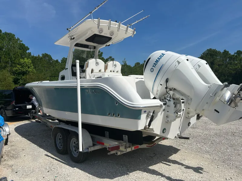 Slide: The Image of 2019 Edgewater 262CC boat on trailer with Yamaha engines, parked outdoors. - 3