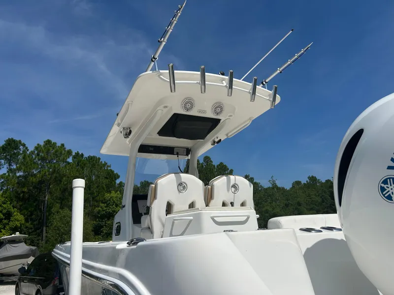 Slide: The Image of 2019 Edgewater 262CC boat with fishing rods, under a clear blue sky. - 4