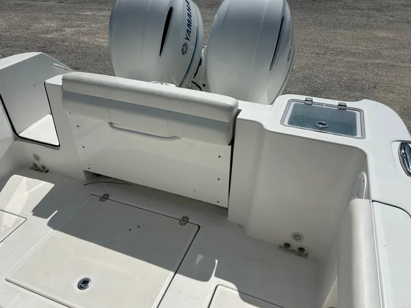 Slide: The Image of 2019 Edgewater 262CC boat interior with dual Yamaha engines and storage compartments. - 5